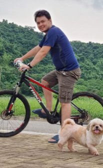 Man Cycling With Dog